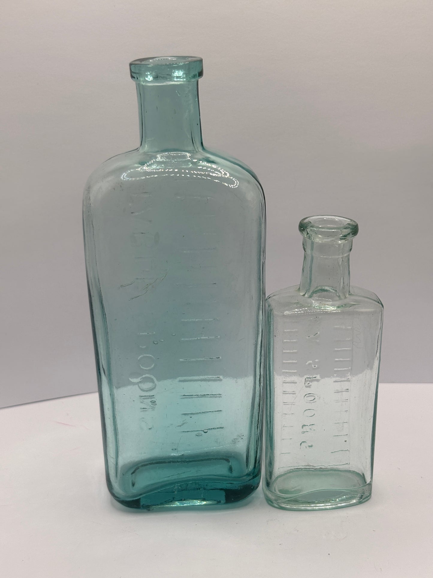 2 old aqua glass tablespoon & teaspoon bottles