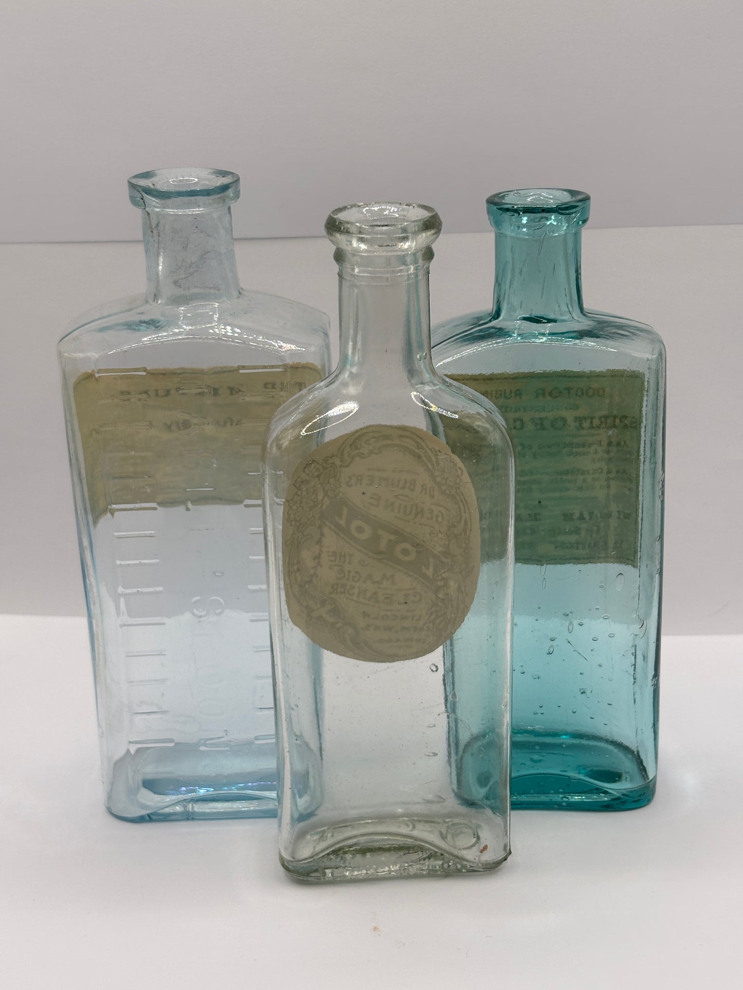 3 old chemist bottles with added labels