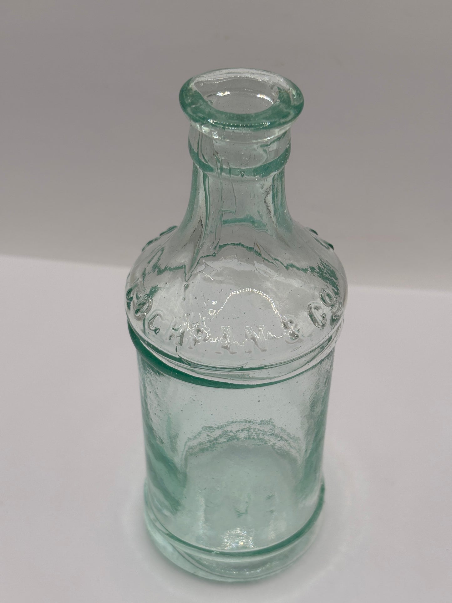 Old tall aqua glass pouring ink. Cochrans liverpool, ink bottle