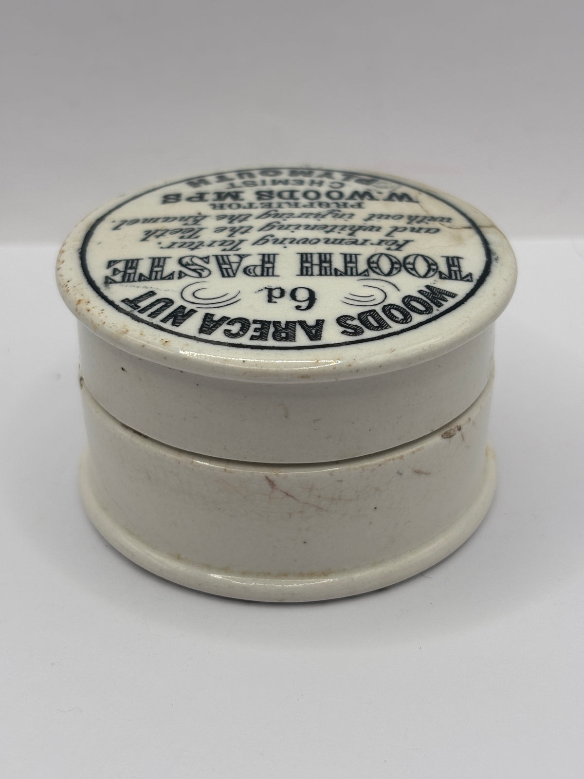 Old advertising lid and base. Woods areca nut tooth paste. Damaged