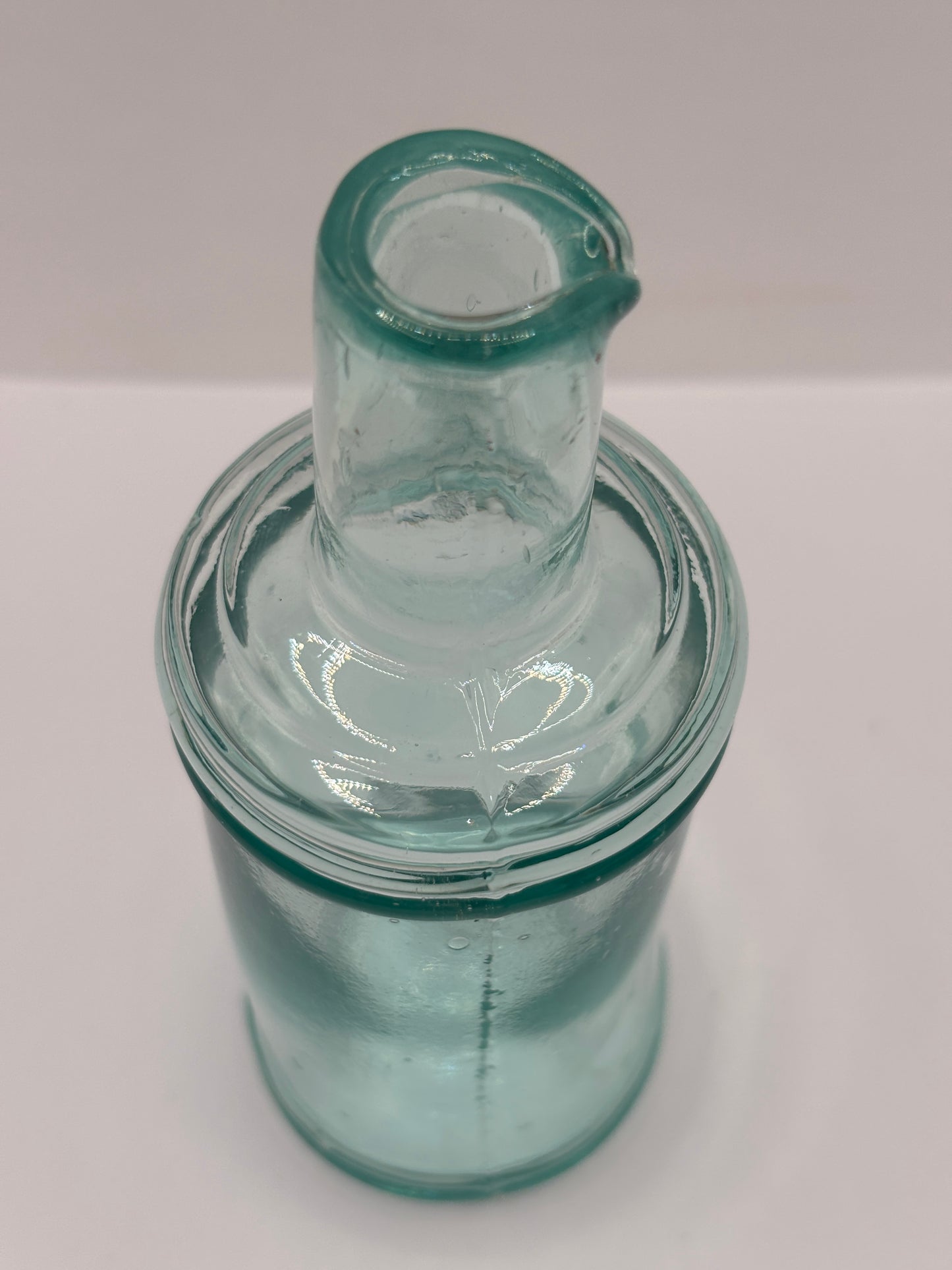 Old tall aqua glass pouring ink, inkwell