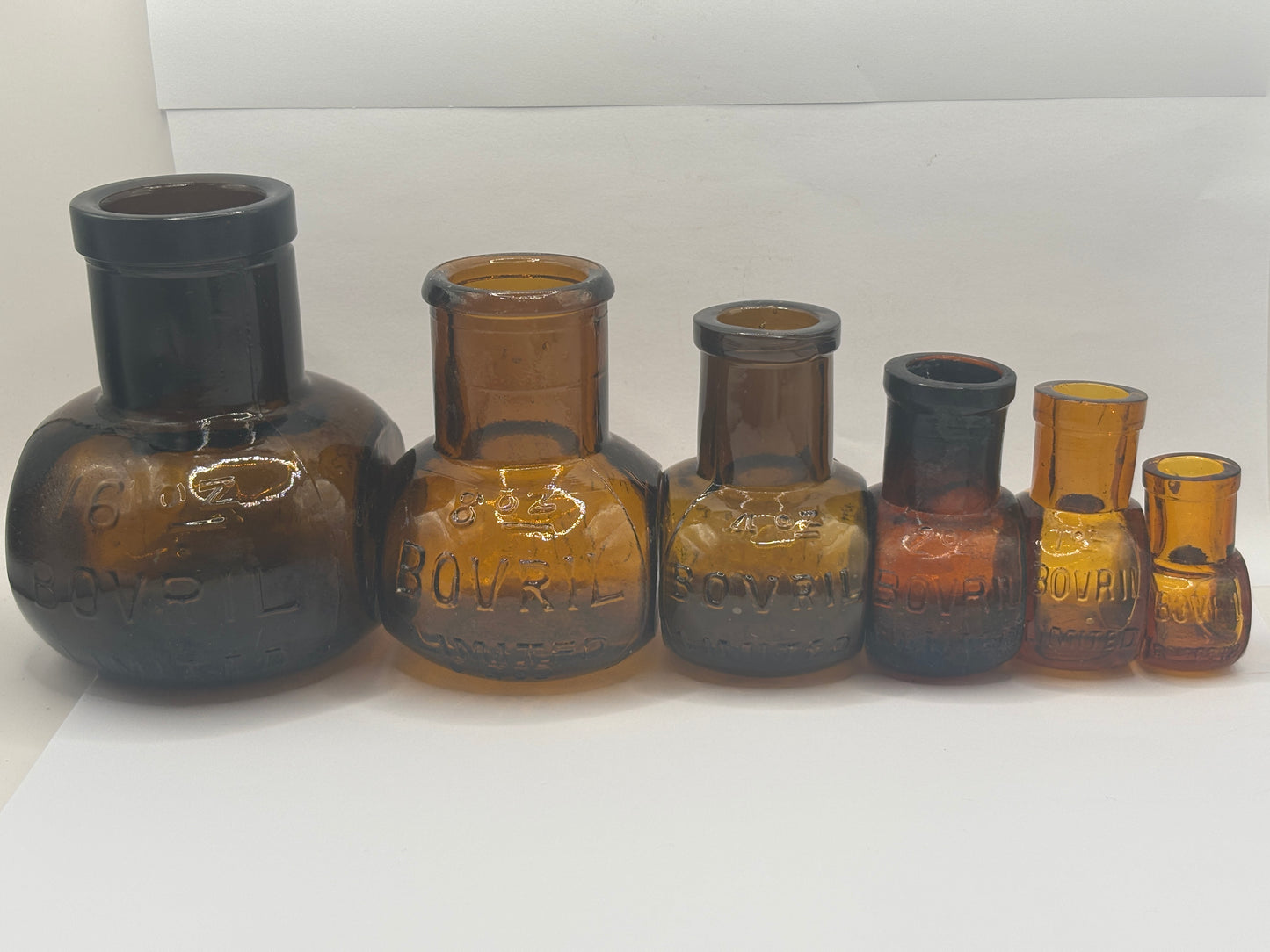 Old full set of amber glass bovril bottles 16oz-1/2 oz