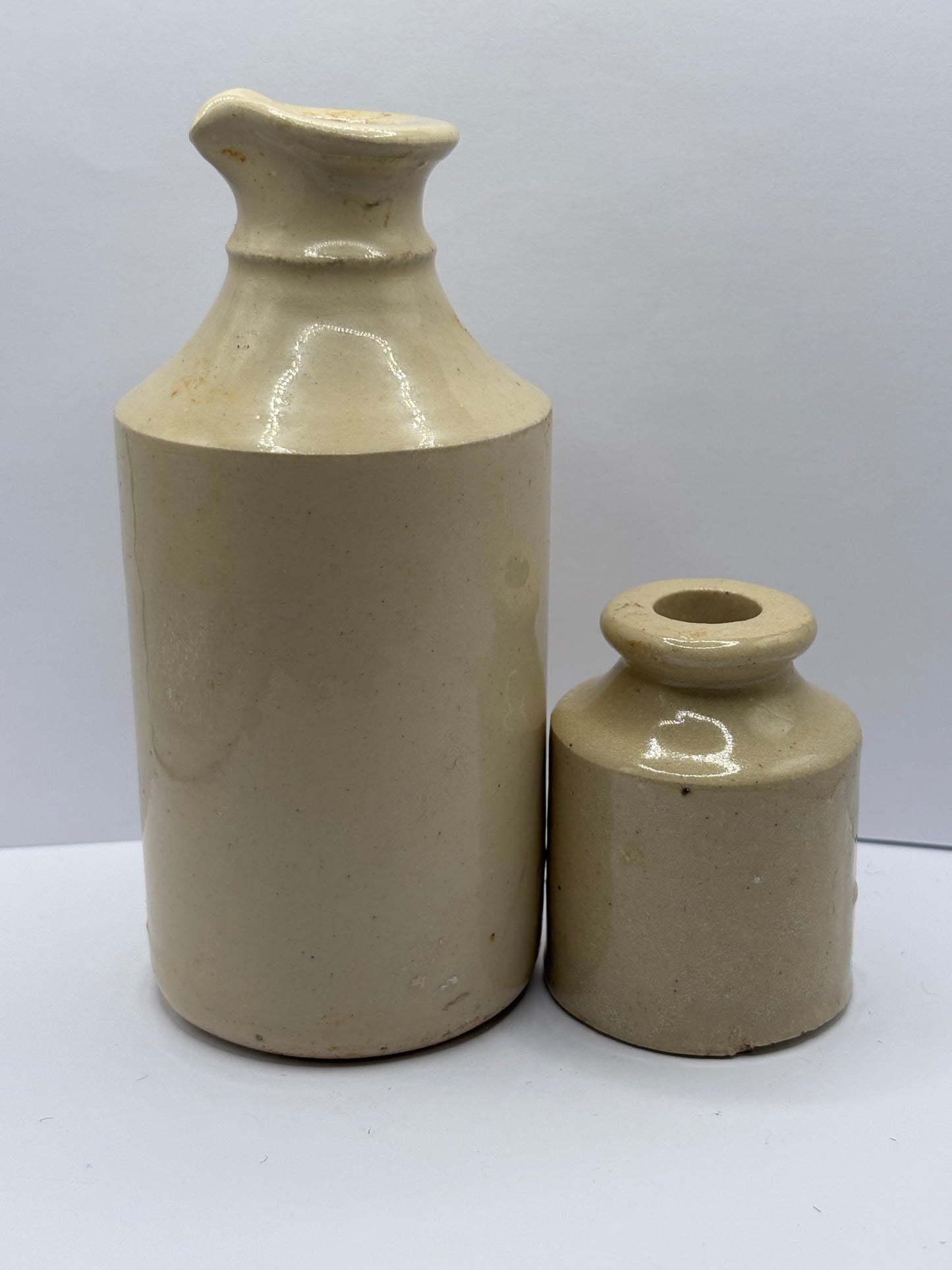 2 old white stoneware bottles