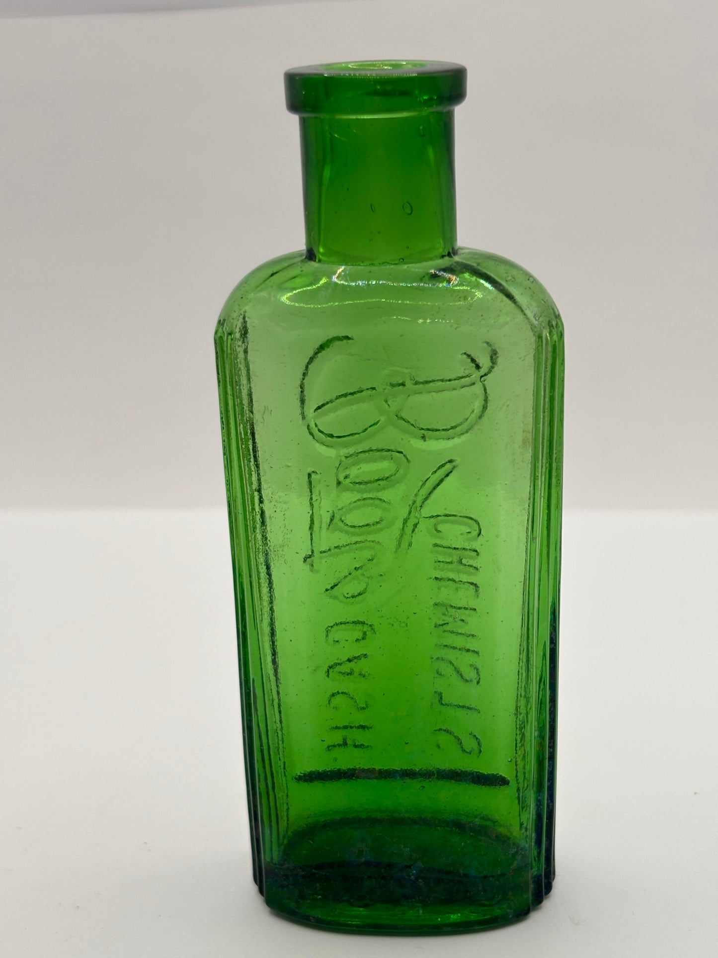 Old green glass advertising bottle. Boots Cash Chemists