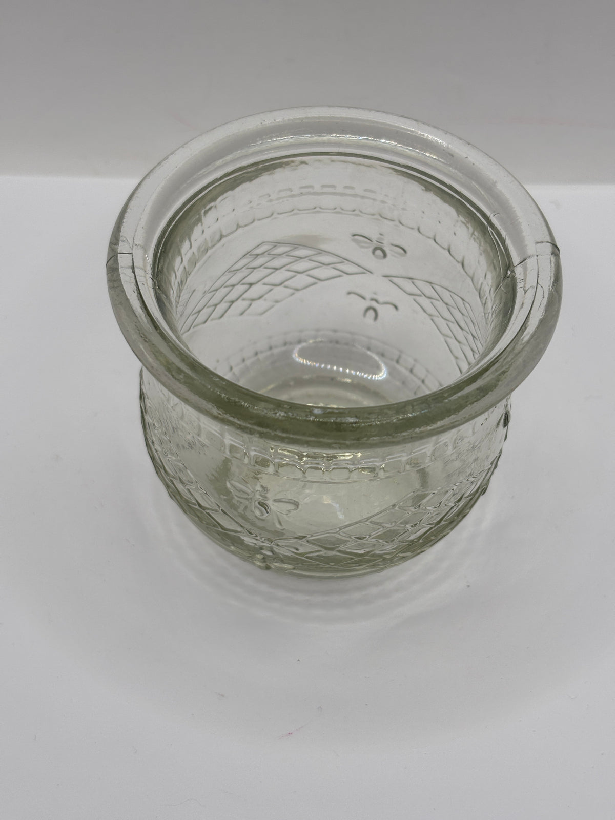 Old clear glass honey pot, honey bees
