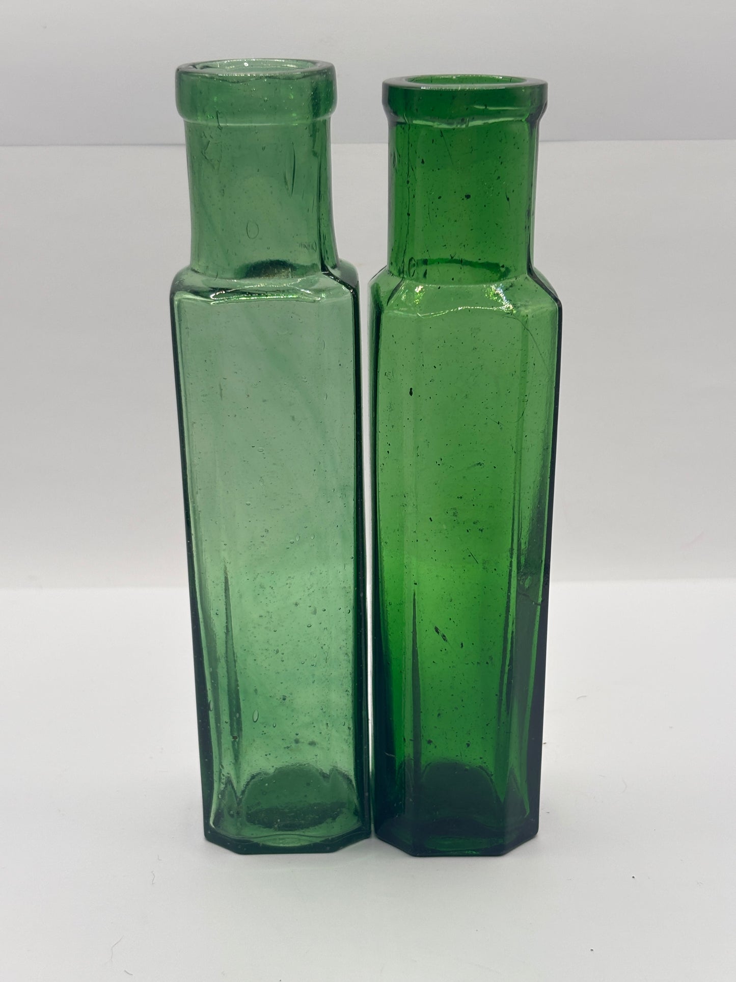 2 old green glass bottles