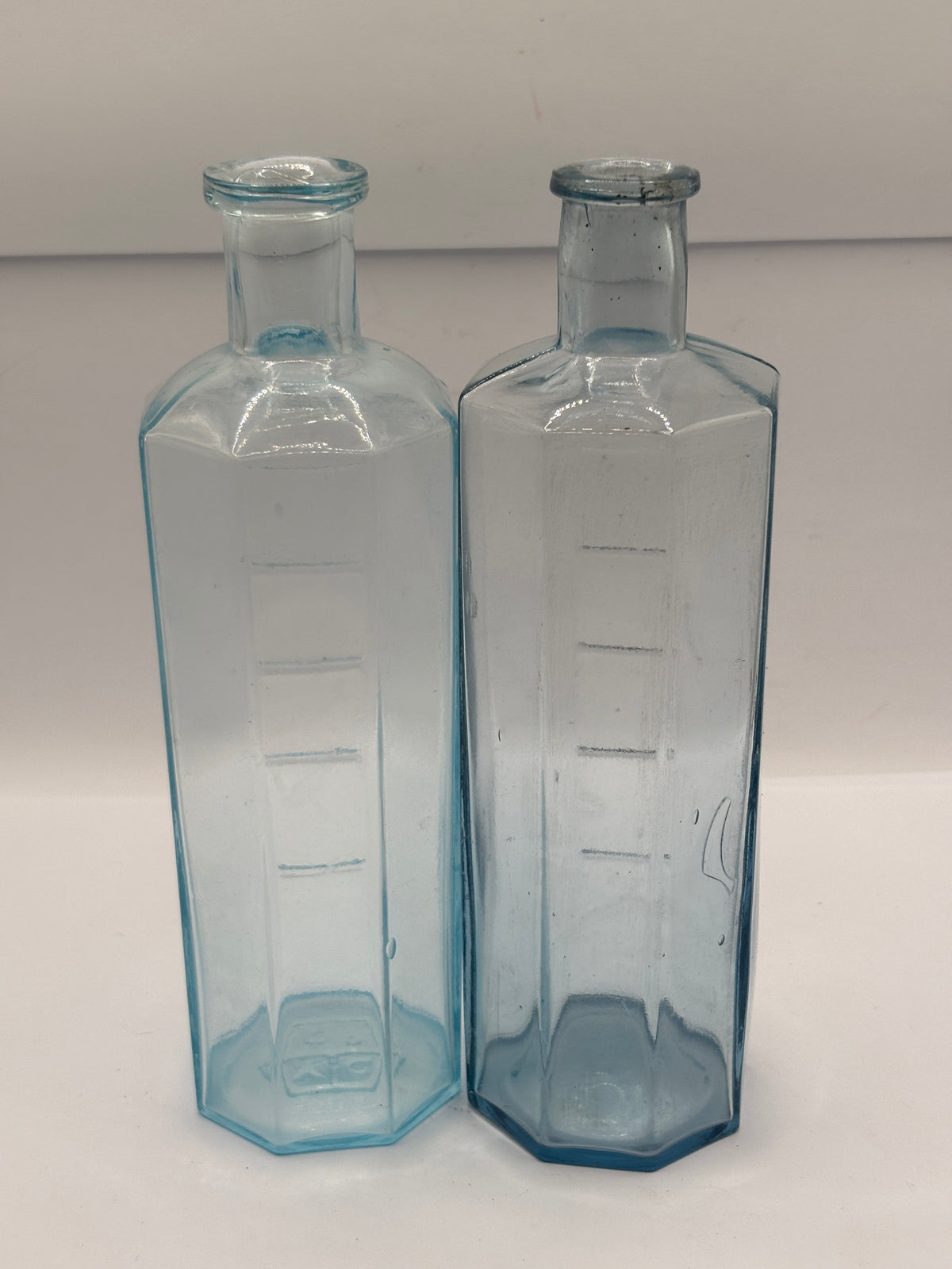 2 old glass medicine bottles