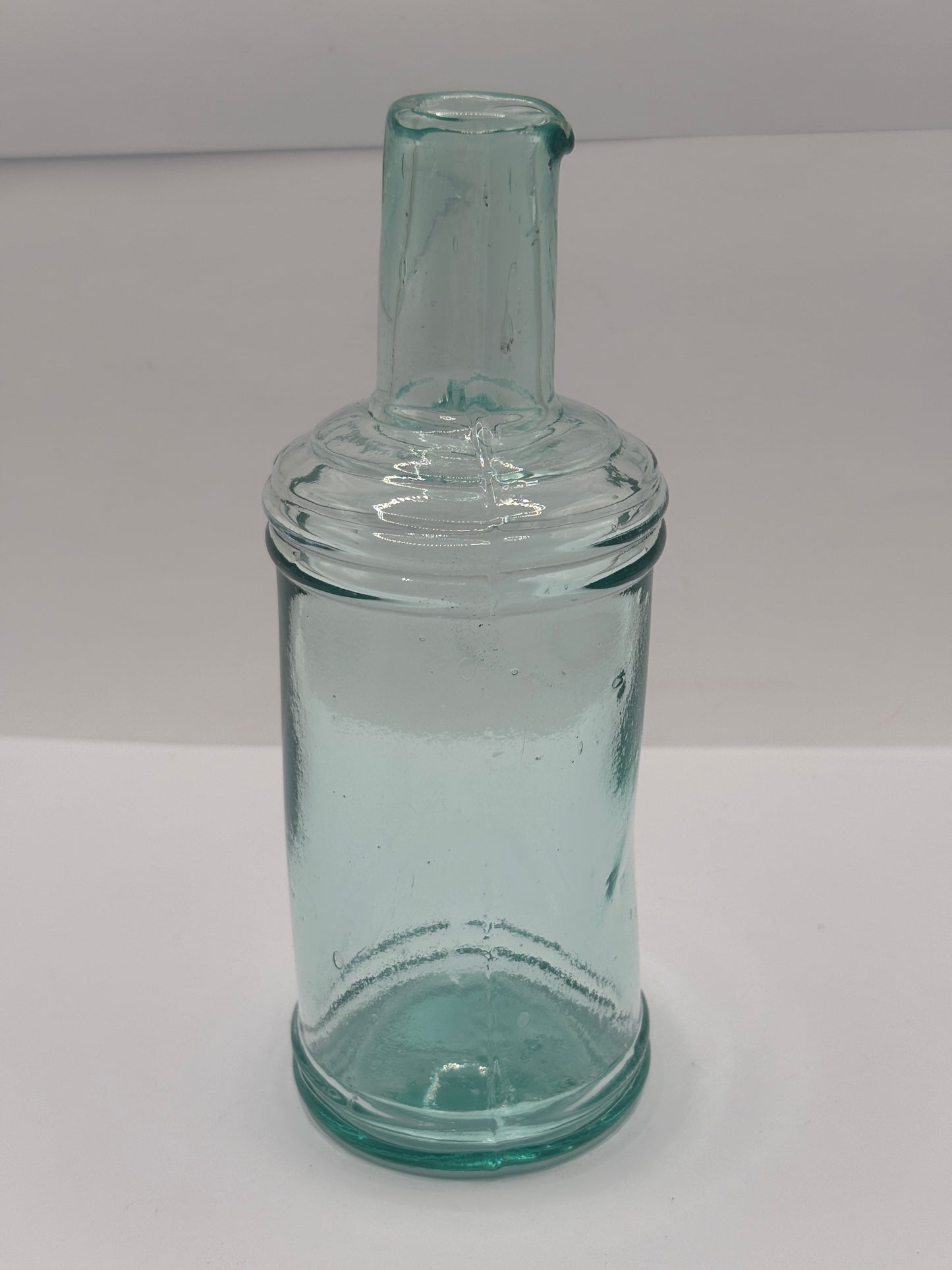 Old tall aqua glass pouring ink, inkwell