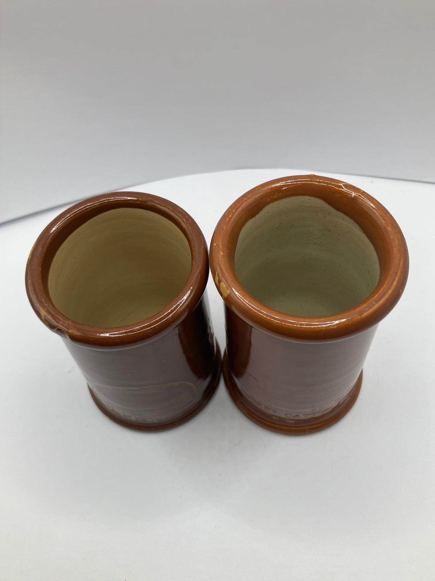 2 brown stoneware cream pots