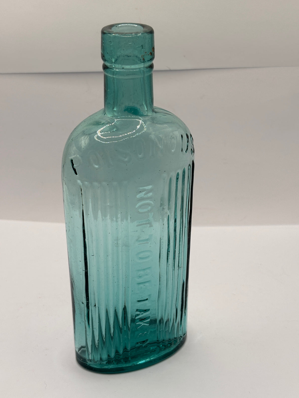 Old aqua glass poison bottle, POISONOUS not to be taken