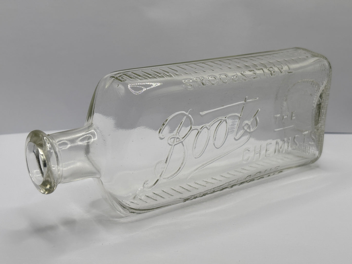 Old clear glass Boots chemist bottle