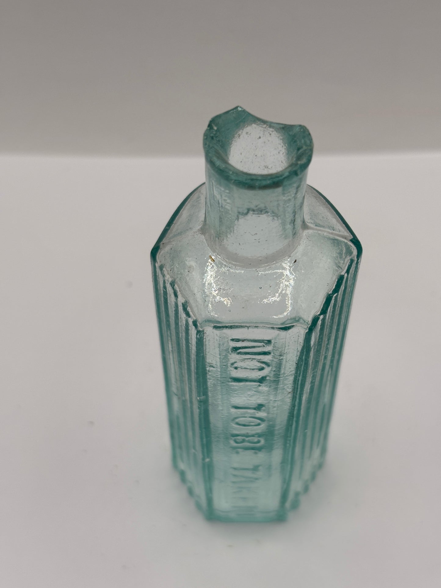 Old aqua glass poison bottle, not to be taken