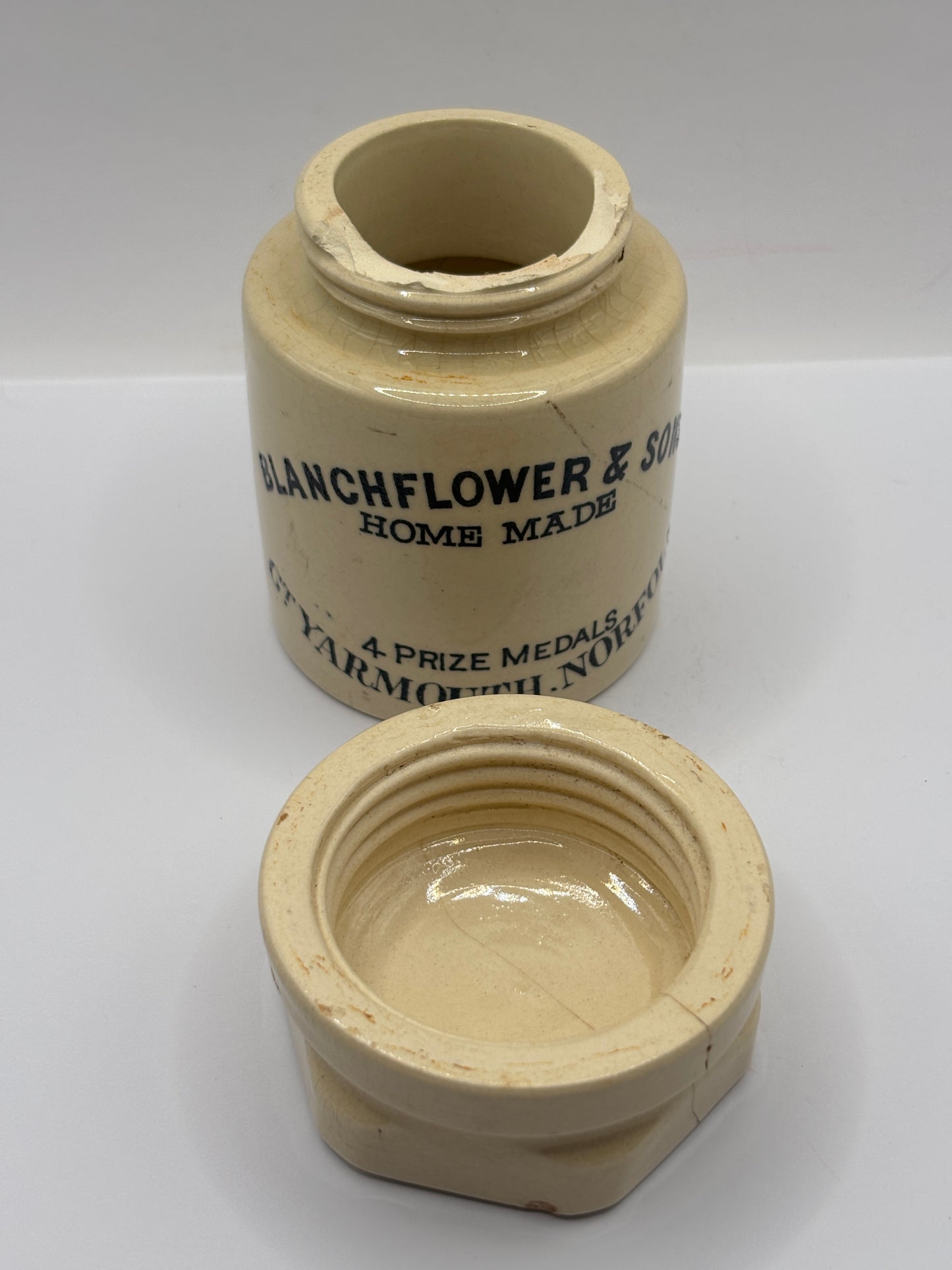 Old stoneware potted meat jar and lid. Blanchflower. Damaged