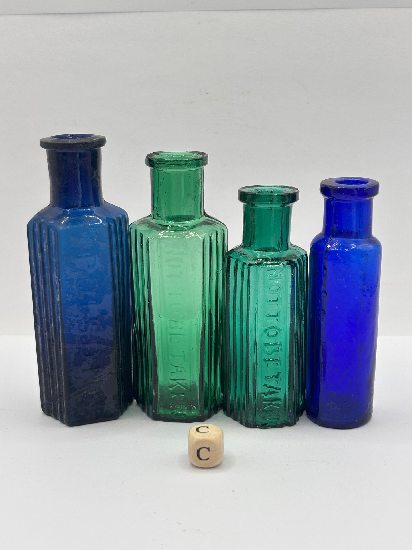 4 old glass poison bottles, chipped (C)