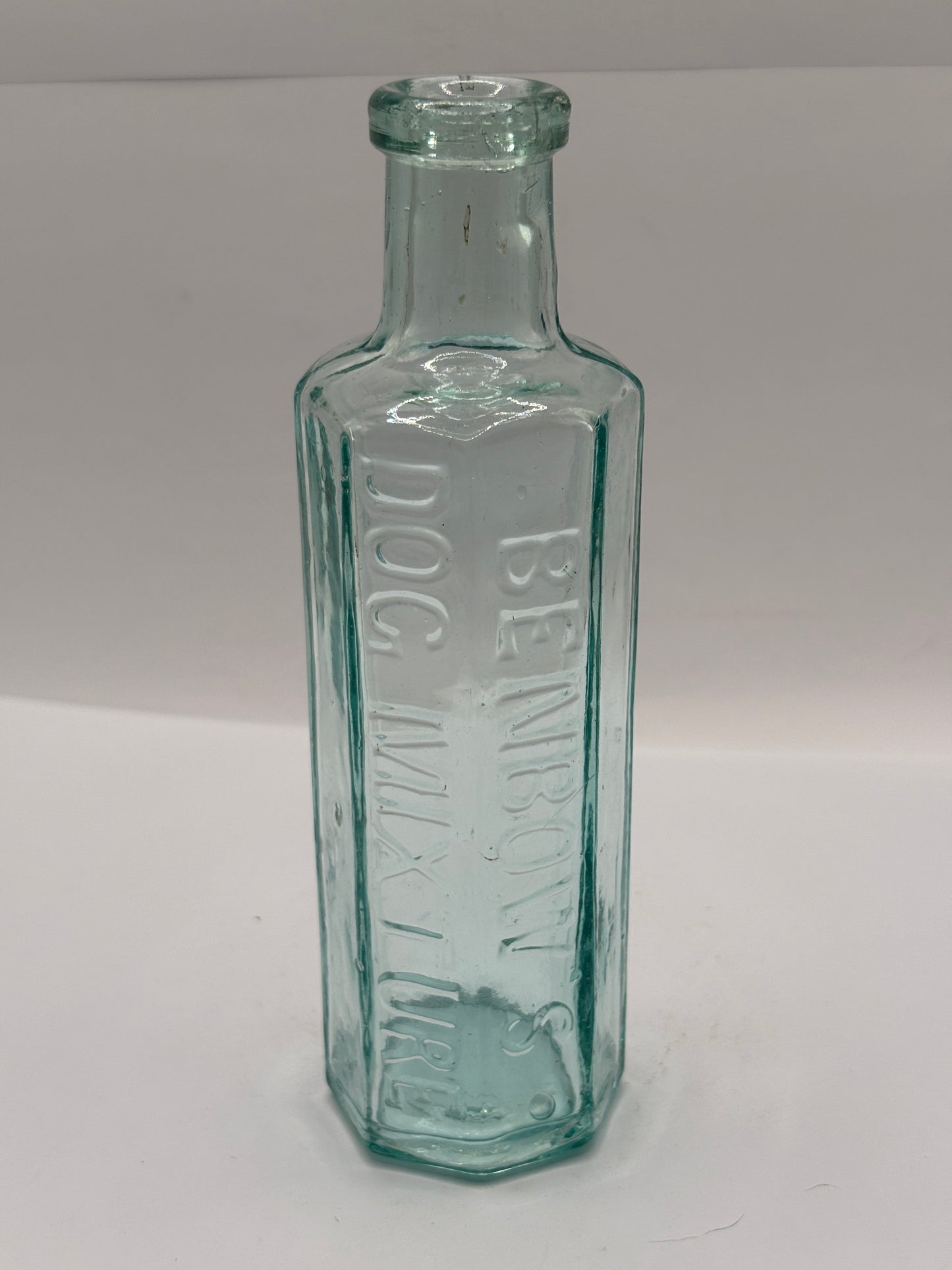 Old aqua glass advertising bottle. Benbows dog mixture
