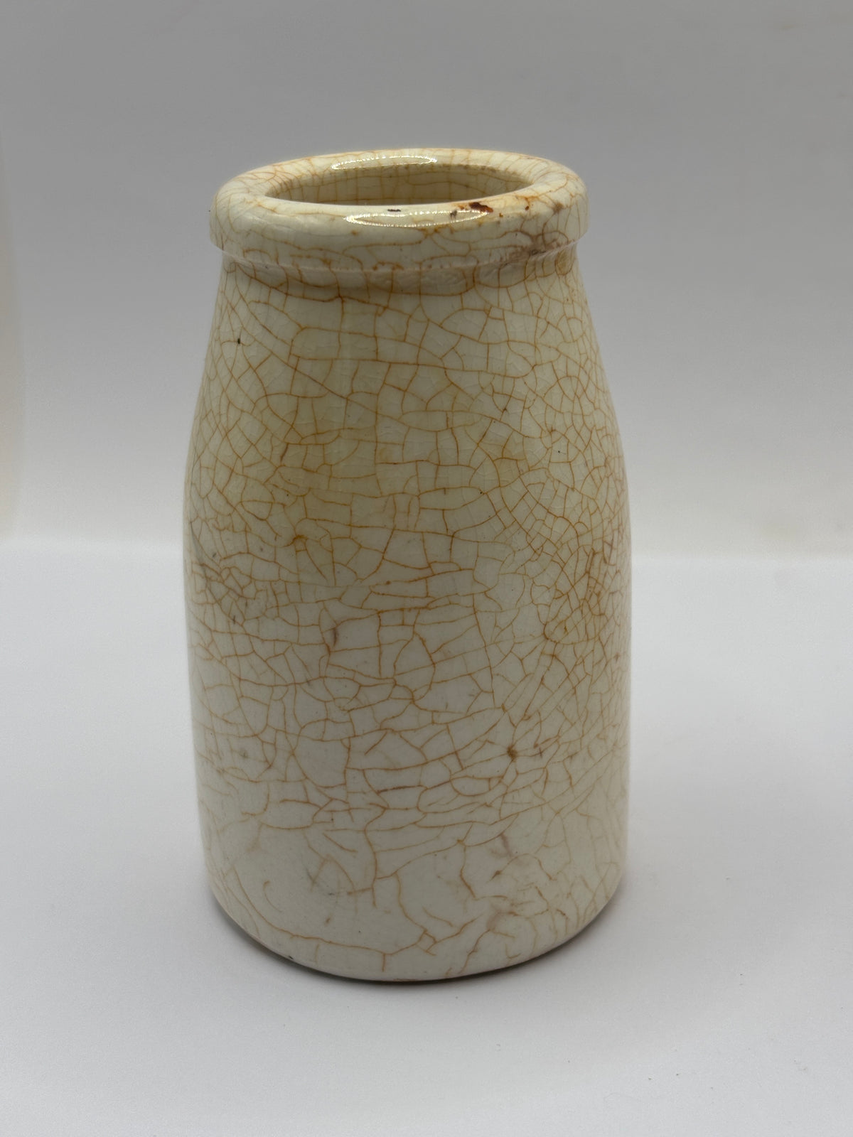 Old plain white stoneware creamer, churn