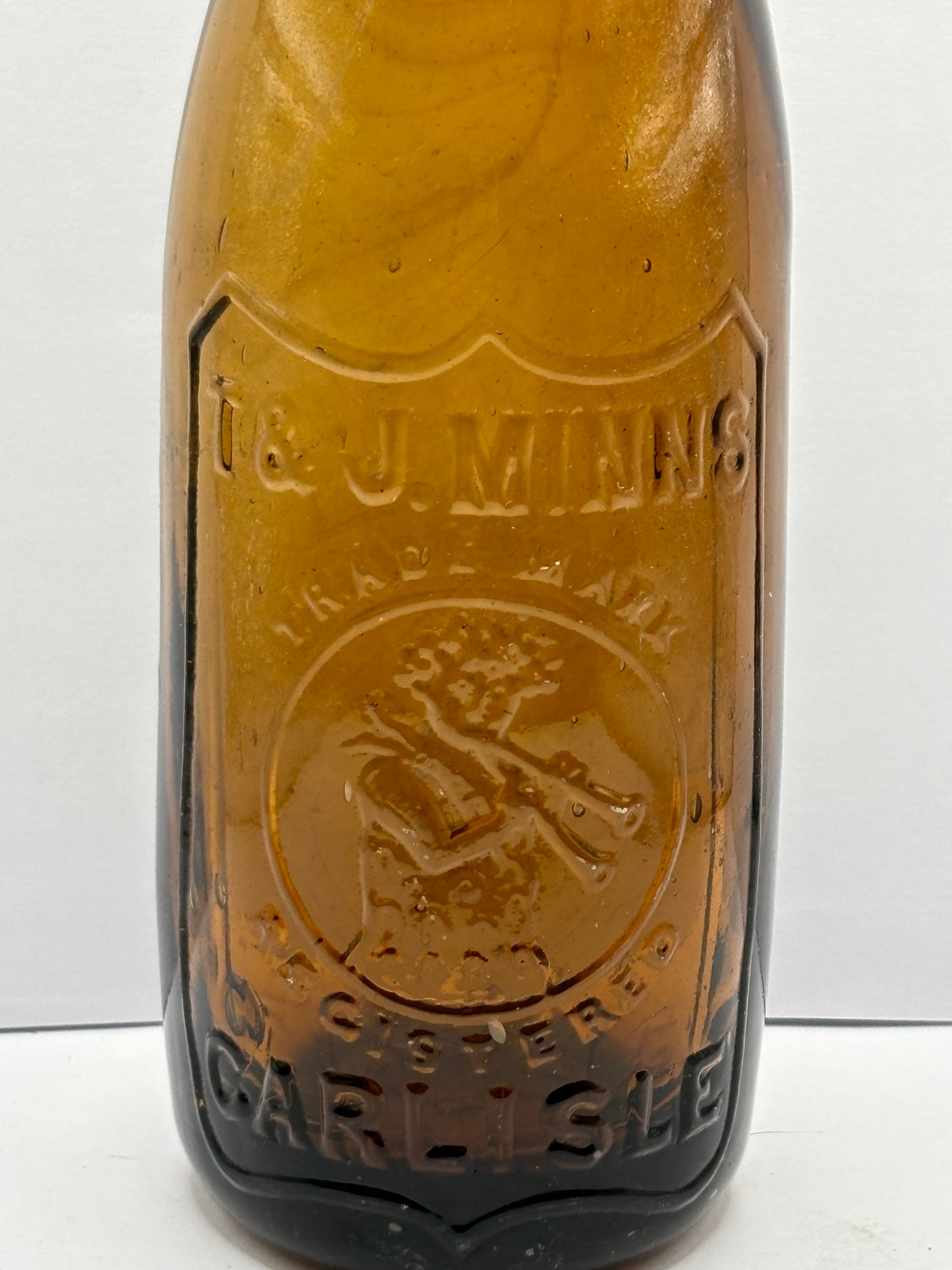 Old amber glass beer bottle, T&J minns Carlisle