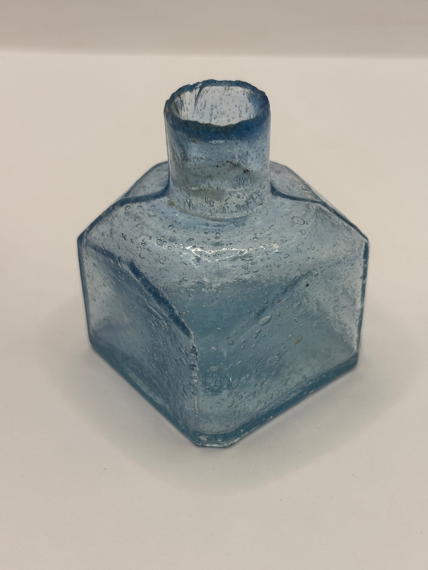 Old blue glass inkwell, ink bottle, penny ink. Lots of air bubbles