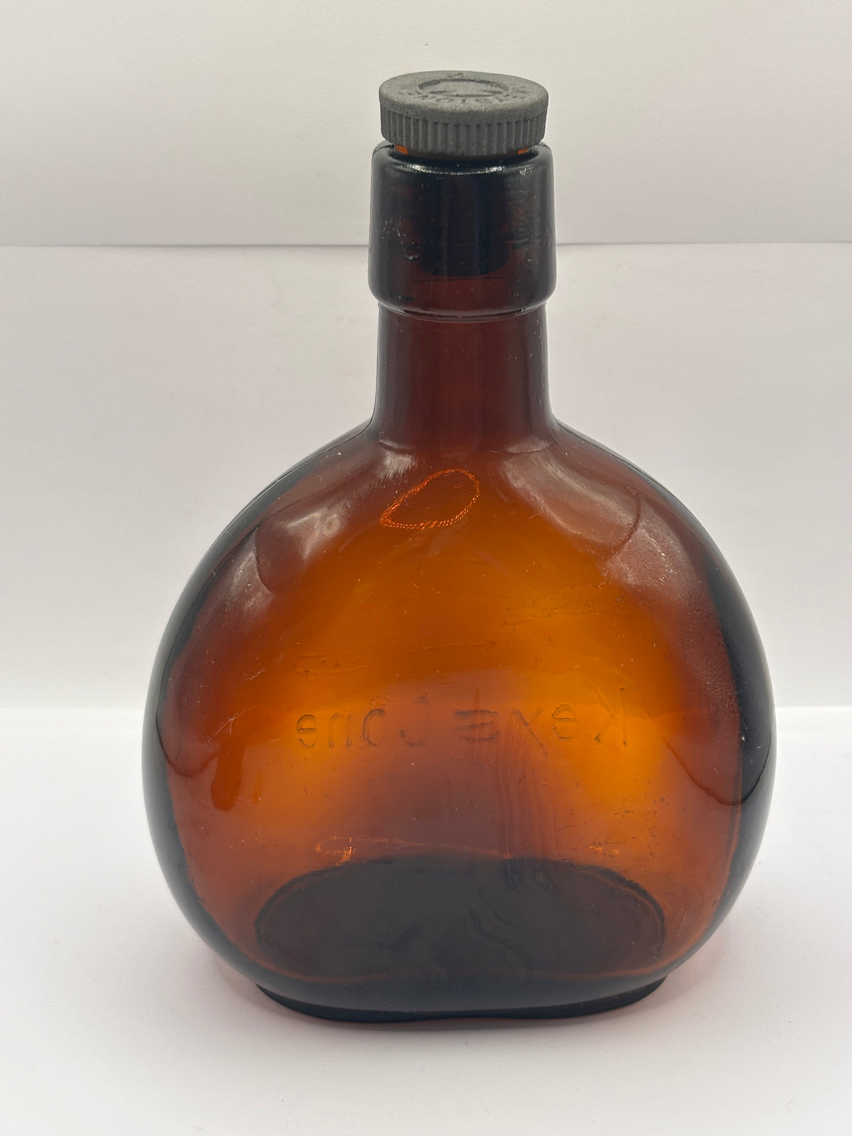 Old amber glass bottle with original stopper