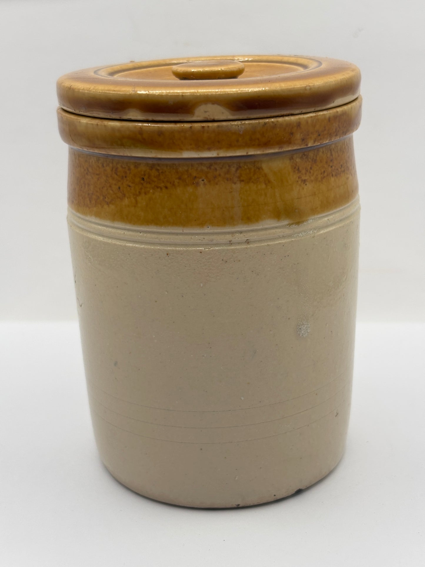 Old brown top stoneware jar and lid
