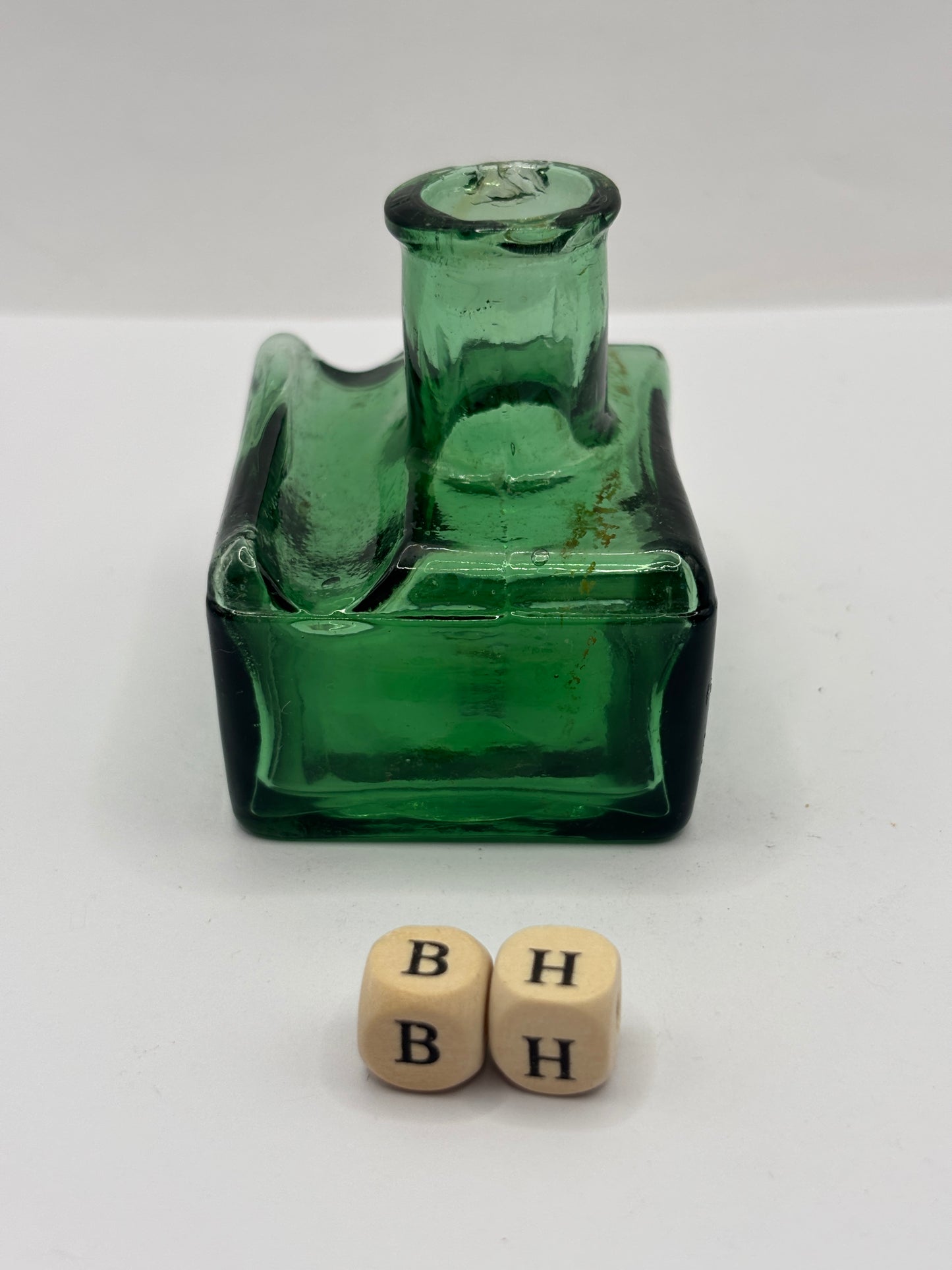 Old green glass ink bottle, inkwell. With pen rest (BH) chipped