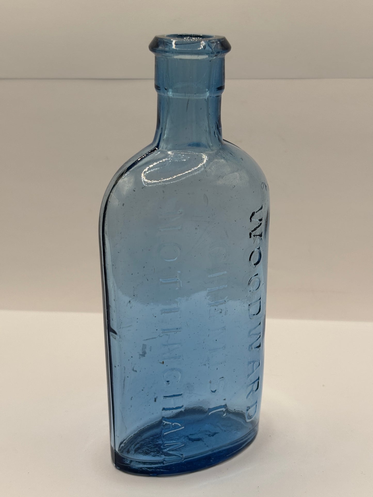 Old blue glass advertising chemist bottle, Woodwards Nottingham