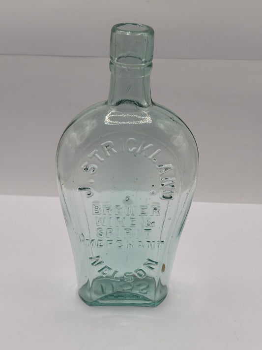 Old glass spirit flask, J.Strickland brewer wine & spirit merchant. Nelson
