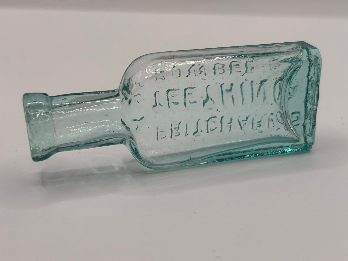 Old small aqua glass advertising bottle. Pritchards teething powders