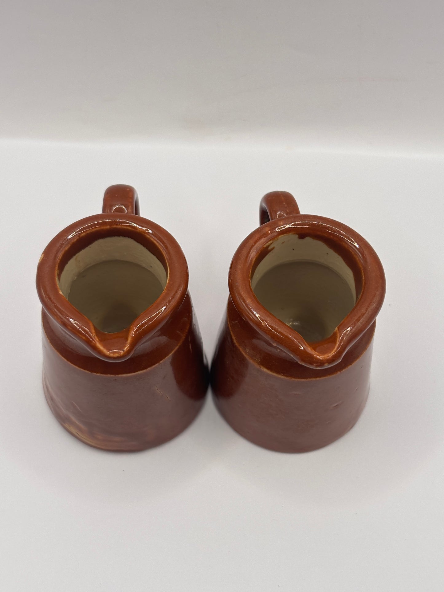 2 old small brown stoneware cream pots, pouring cream