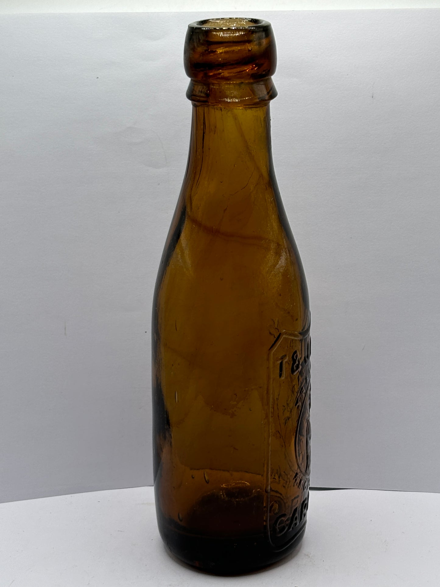 Old amber glass beer bottle, T&J minns Carlisle