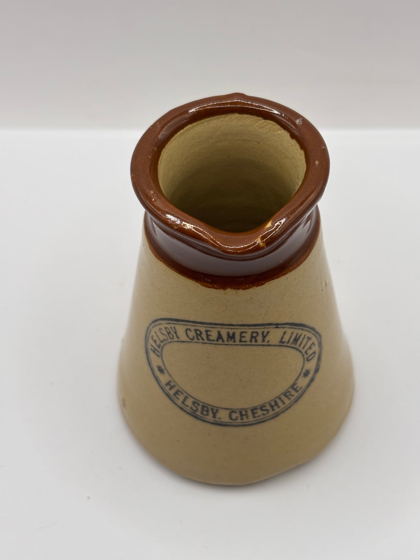 Old stoneware advertising cream pot, Helsby Creamery. Cheshire. Handled
