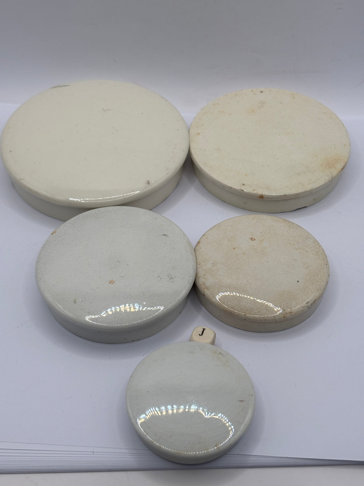 5 old stoneware lids, stackers (J)