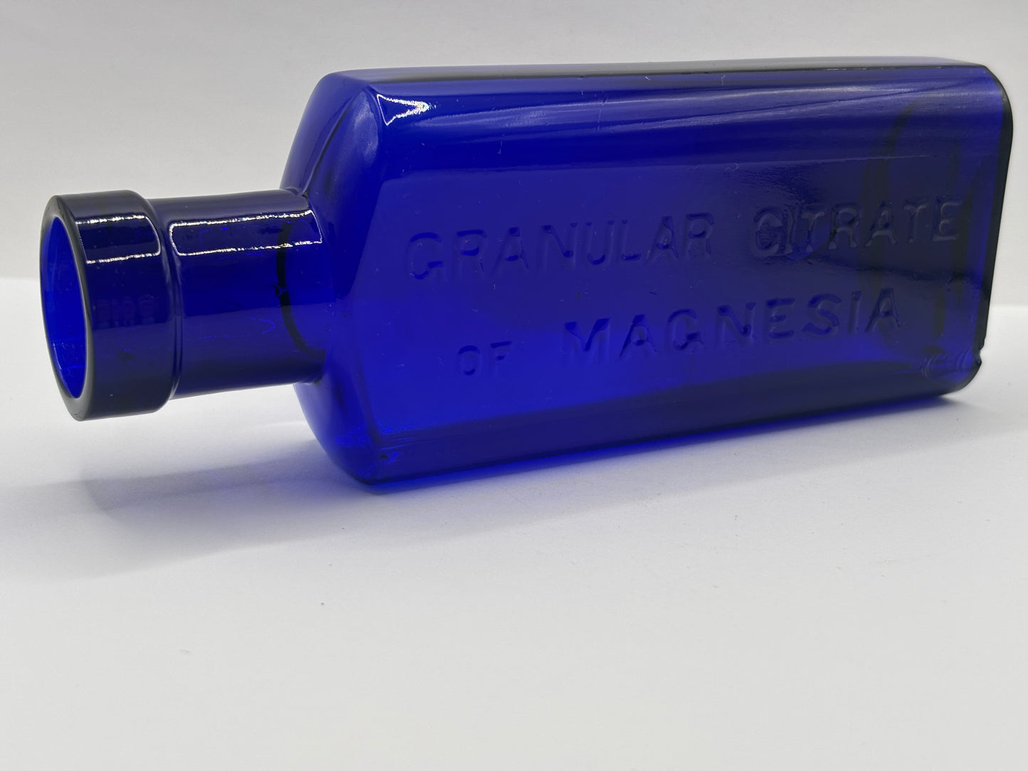 Old blue glass advertising bottle, Granular citrate of magnesia