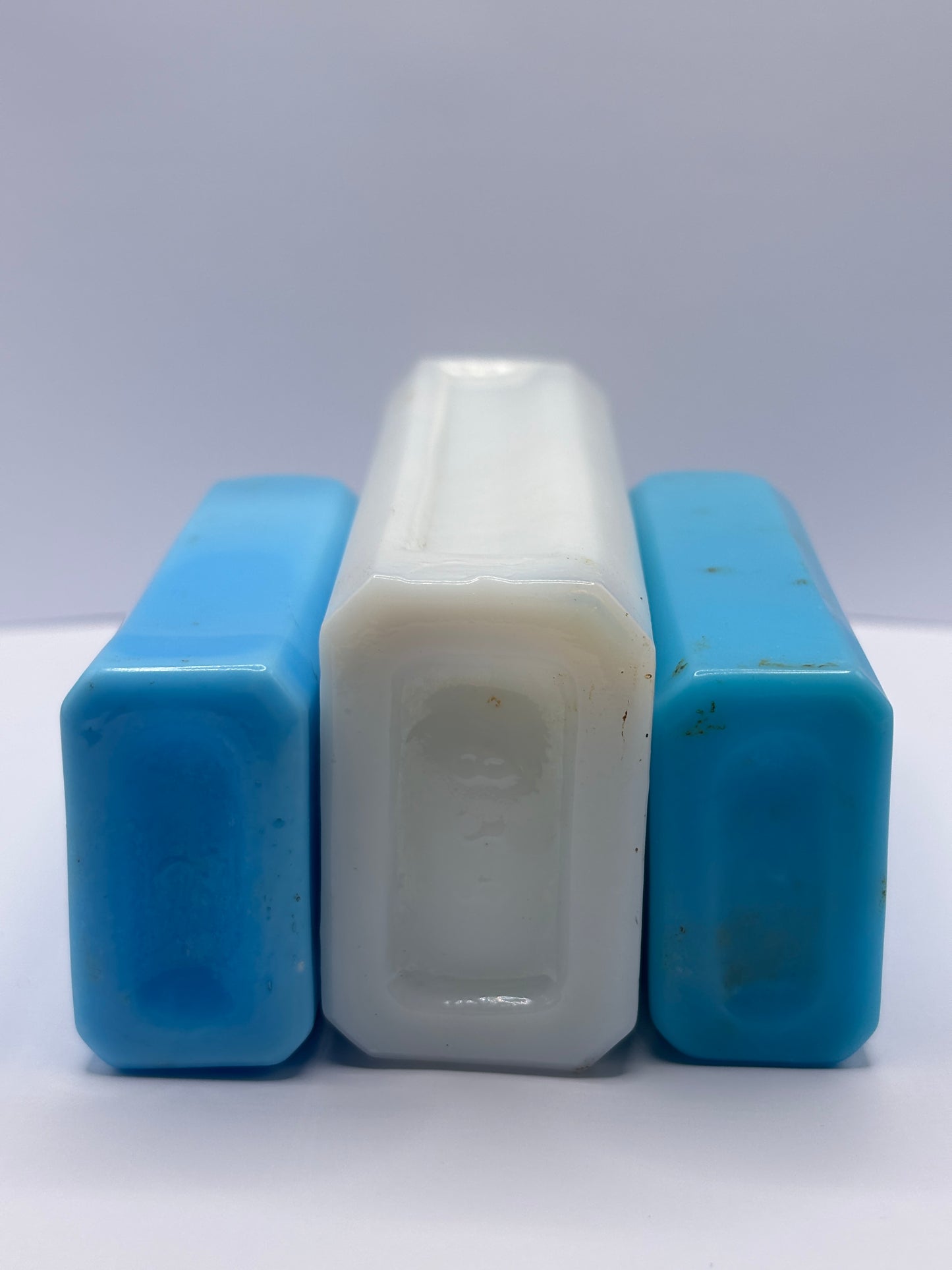 3 old milk glass bottles