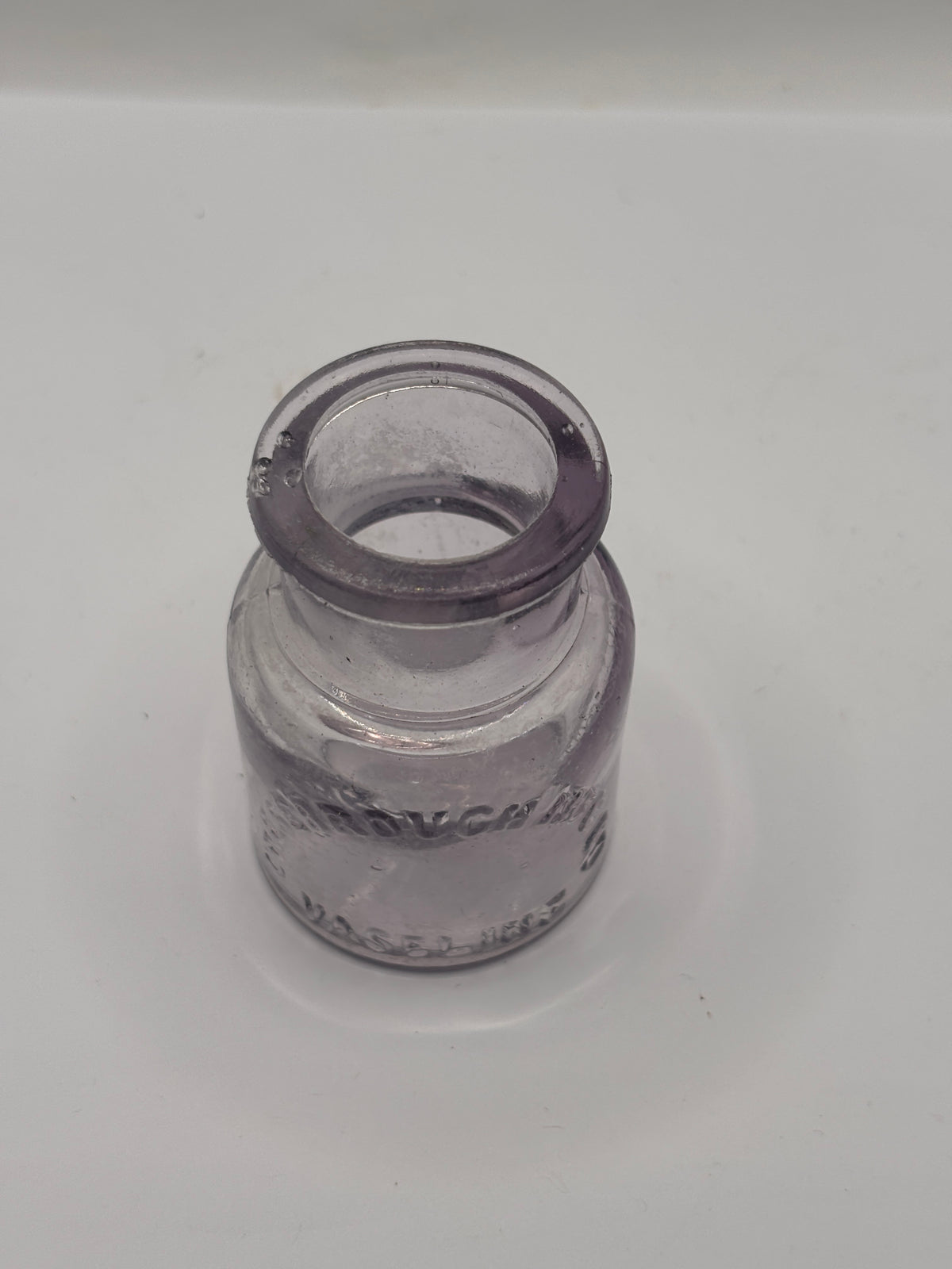 Old crusty purple glass vaseline jar