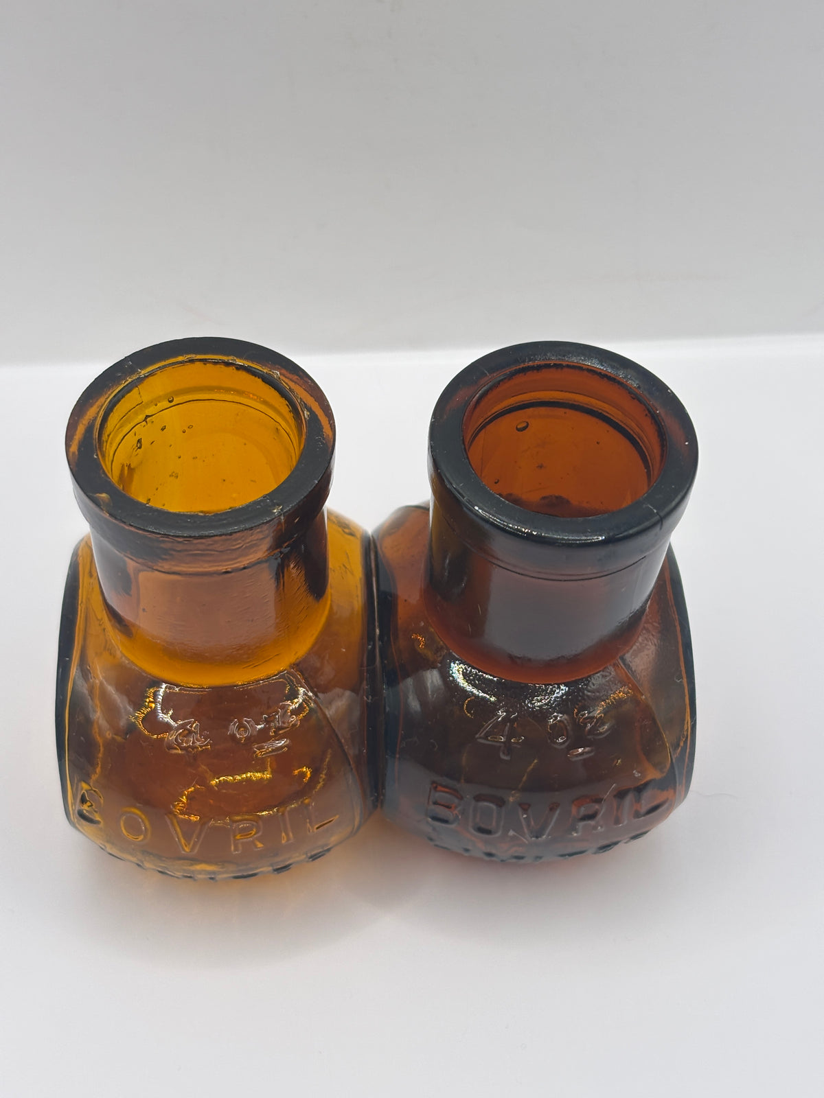 2 old 4Oz amber glass advertising Bovril bottles