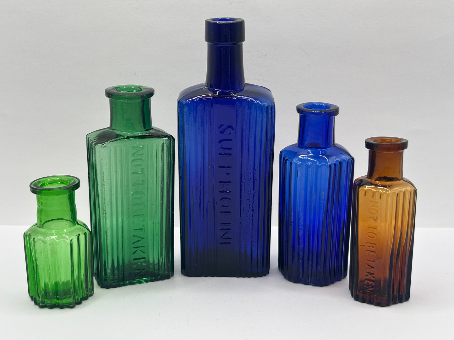 5 old glass poison bottles, not to be taken
