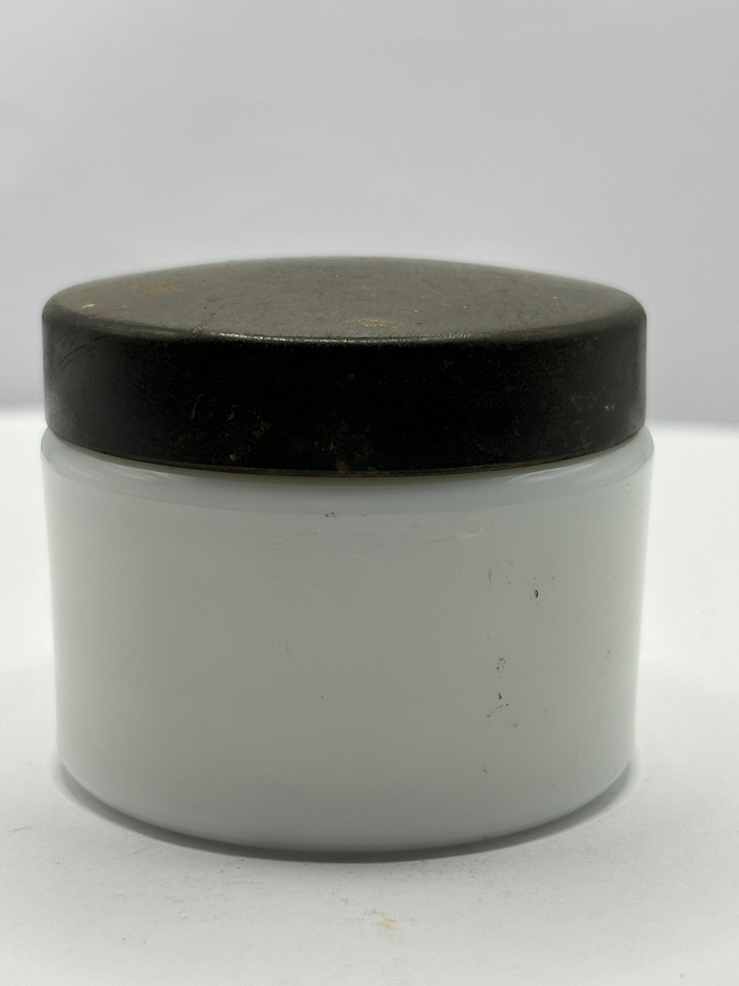 Small milk glass jar with original lid