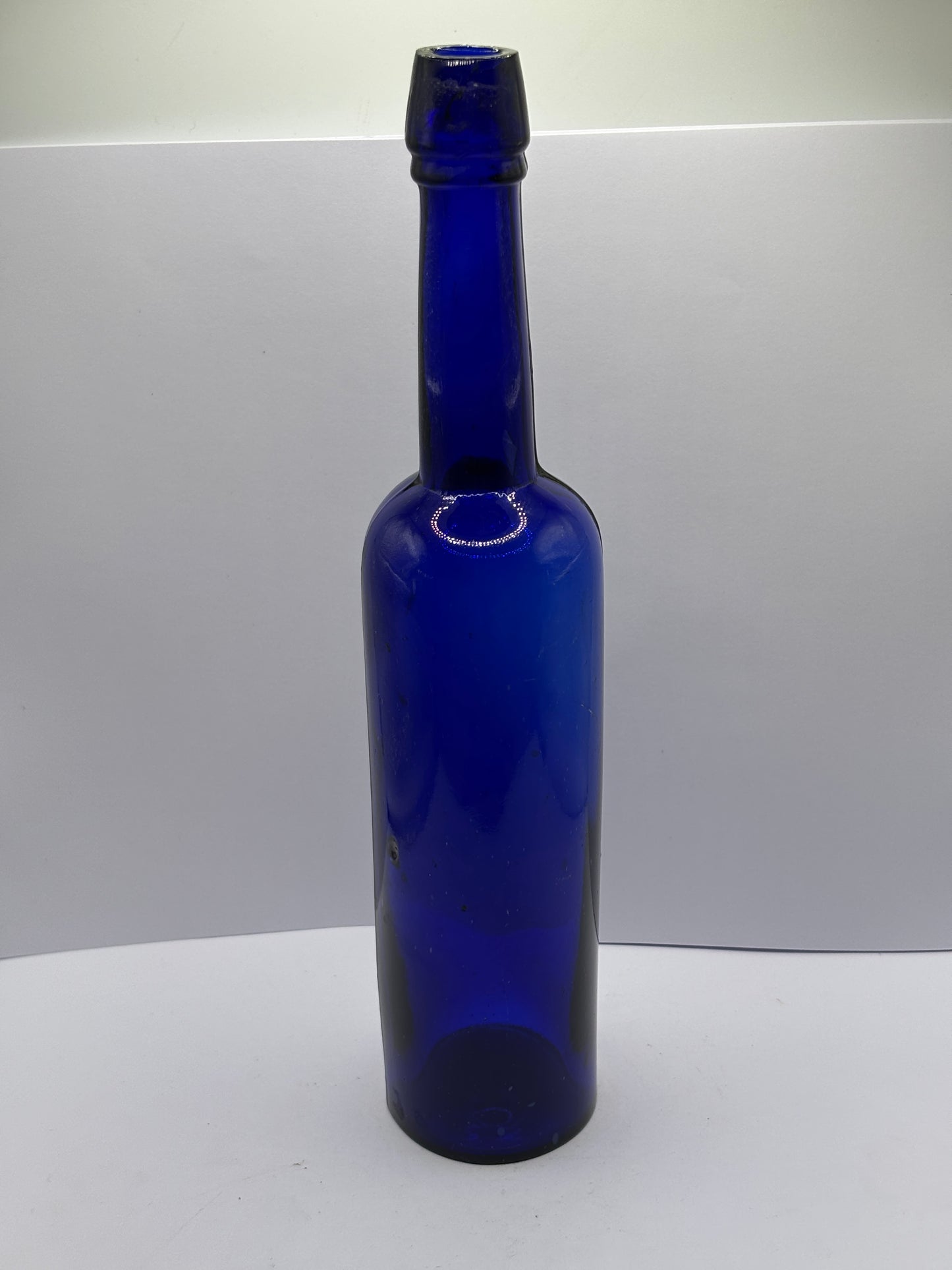 Tall blue castor oil bottle 24cms