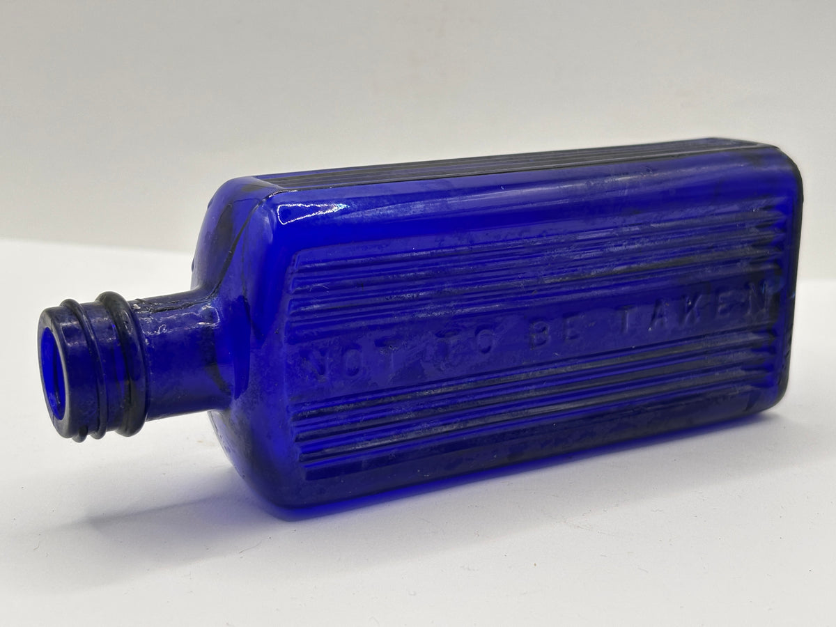 old blue glass ribbed poison bottle, not to be taken