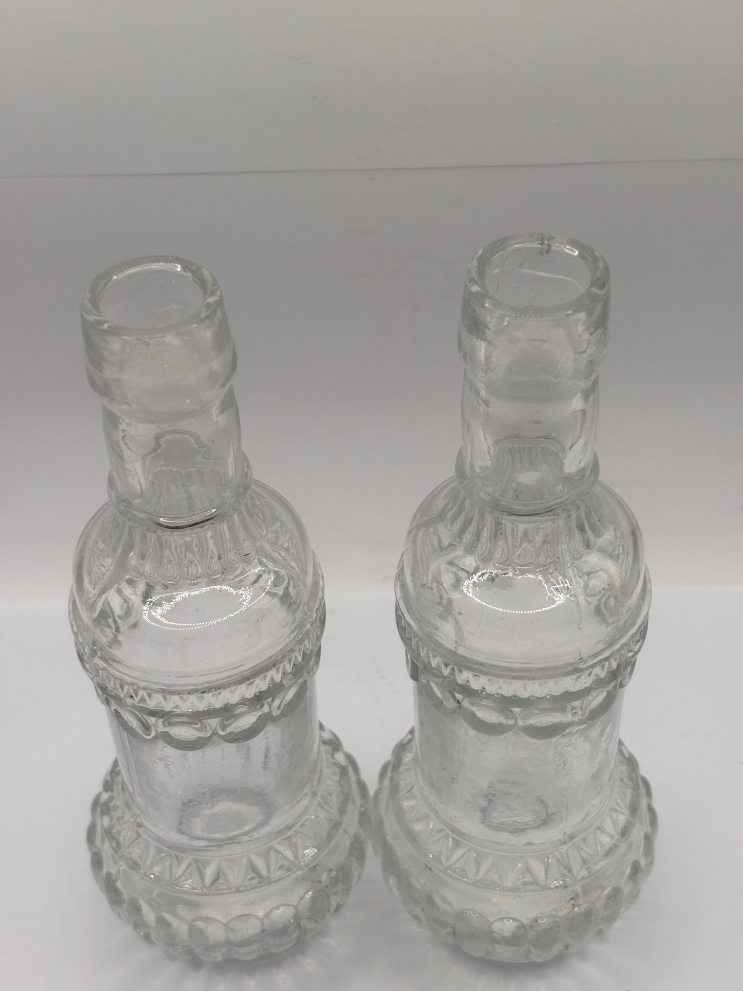 2 old clear glass bottles, soda?