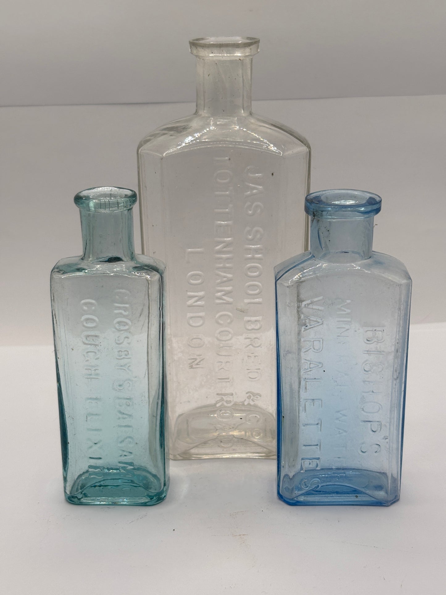 3 old glass advertising chemist bottles
