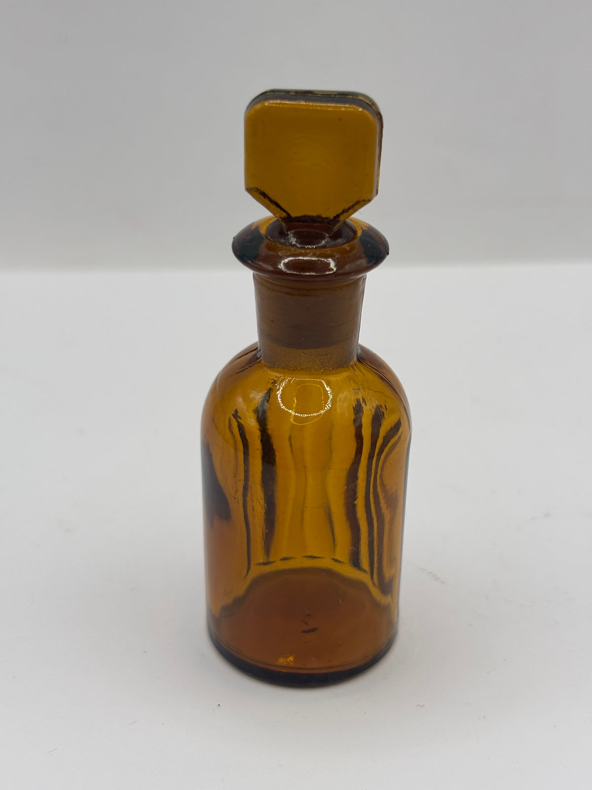 Small amber glass poison bottle with original stopper