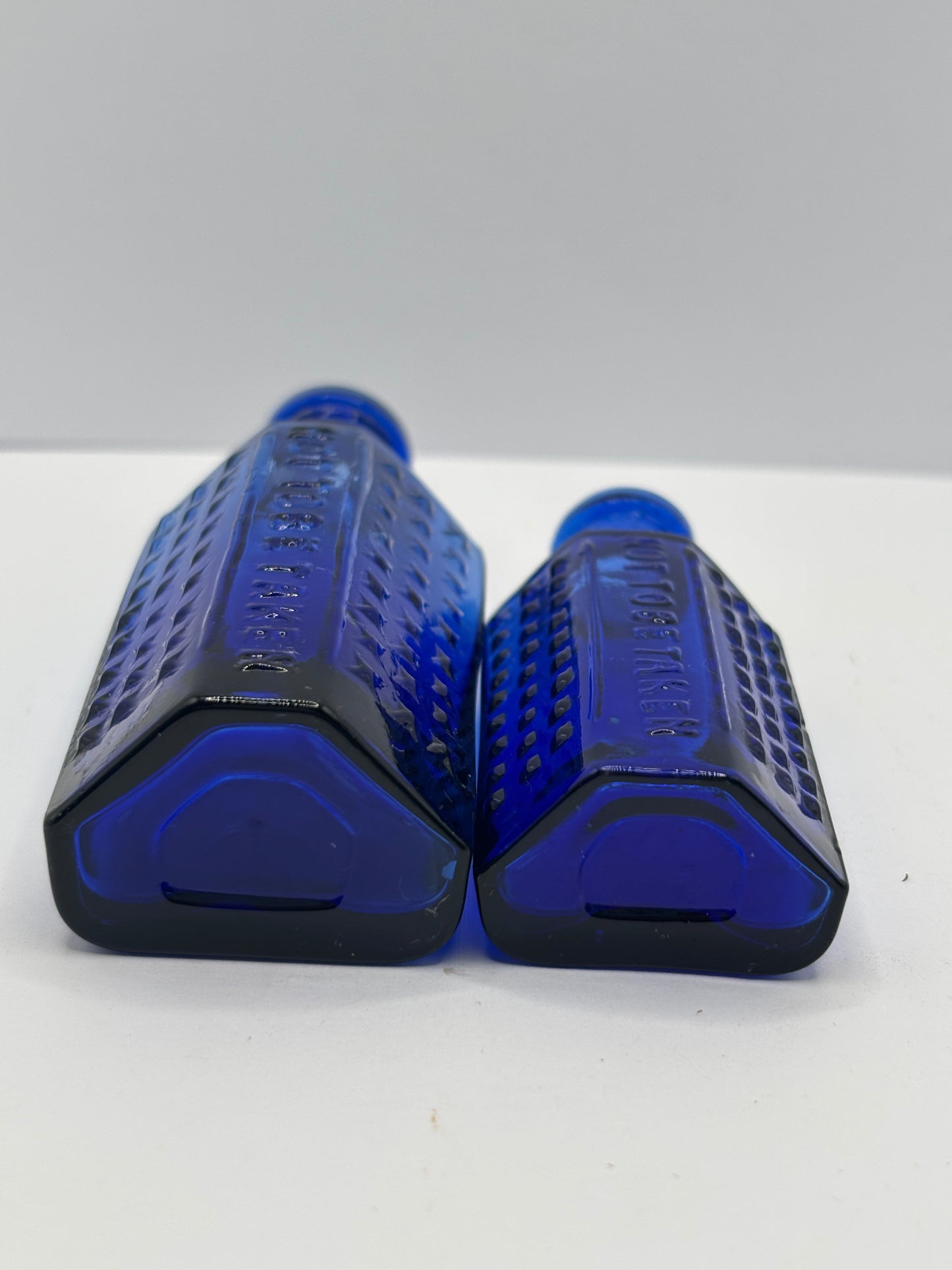 2 old blue flat back poison bottles