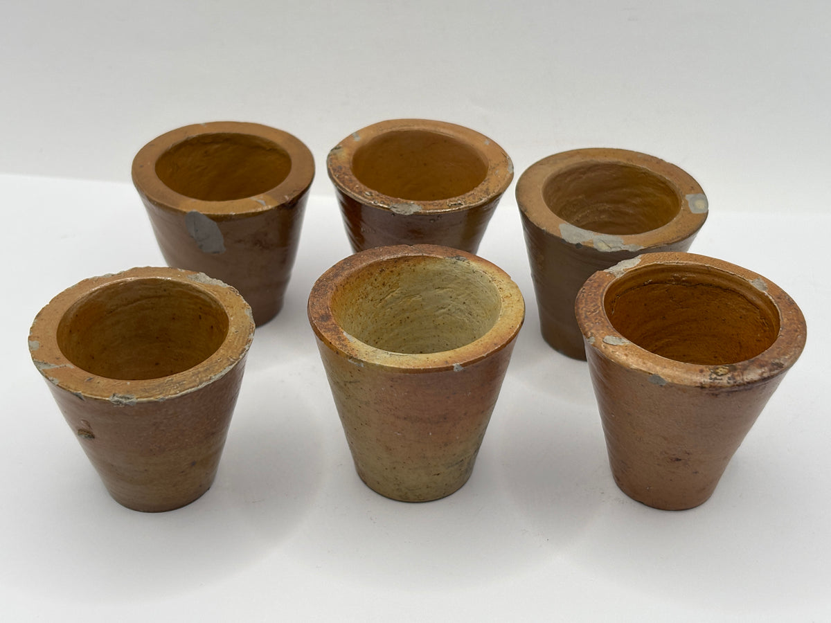 5 small brown stoneware pots. Chipped