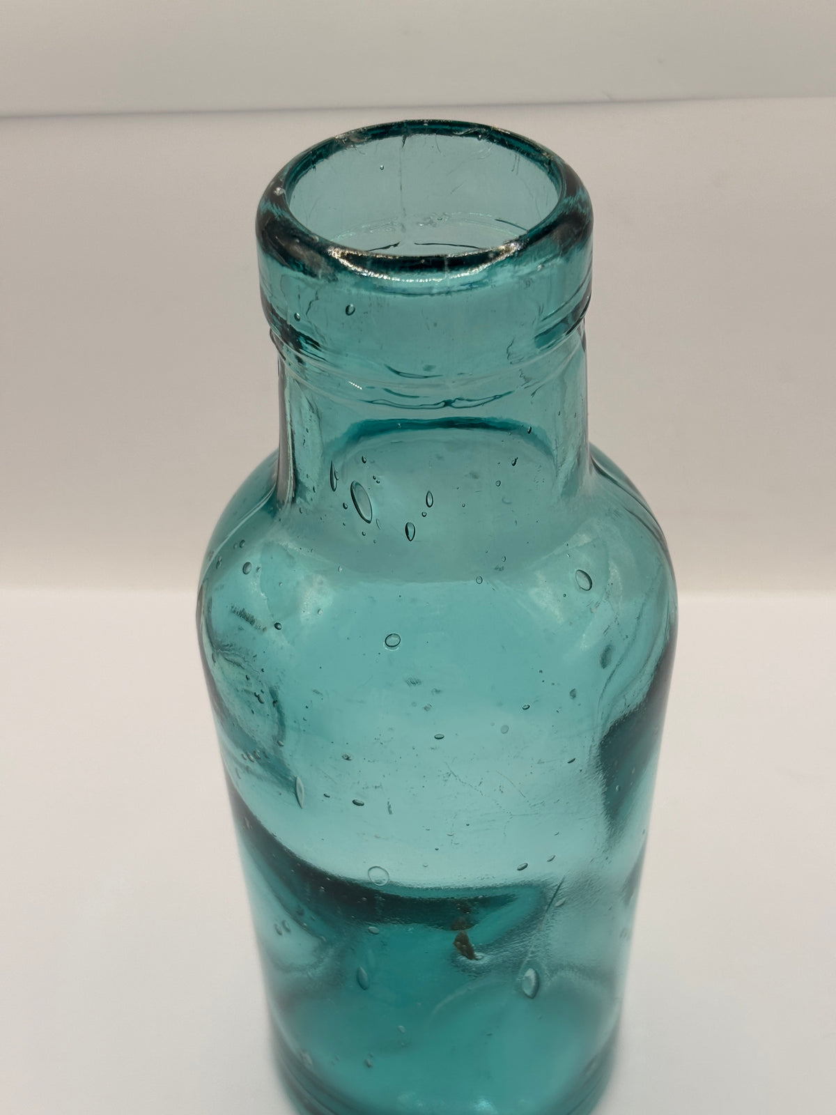Old dark aqua glass jar