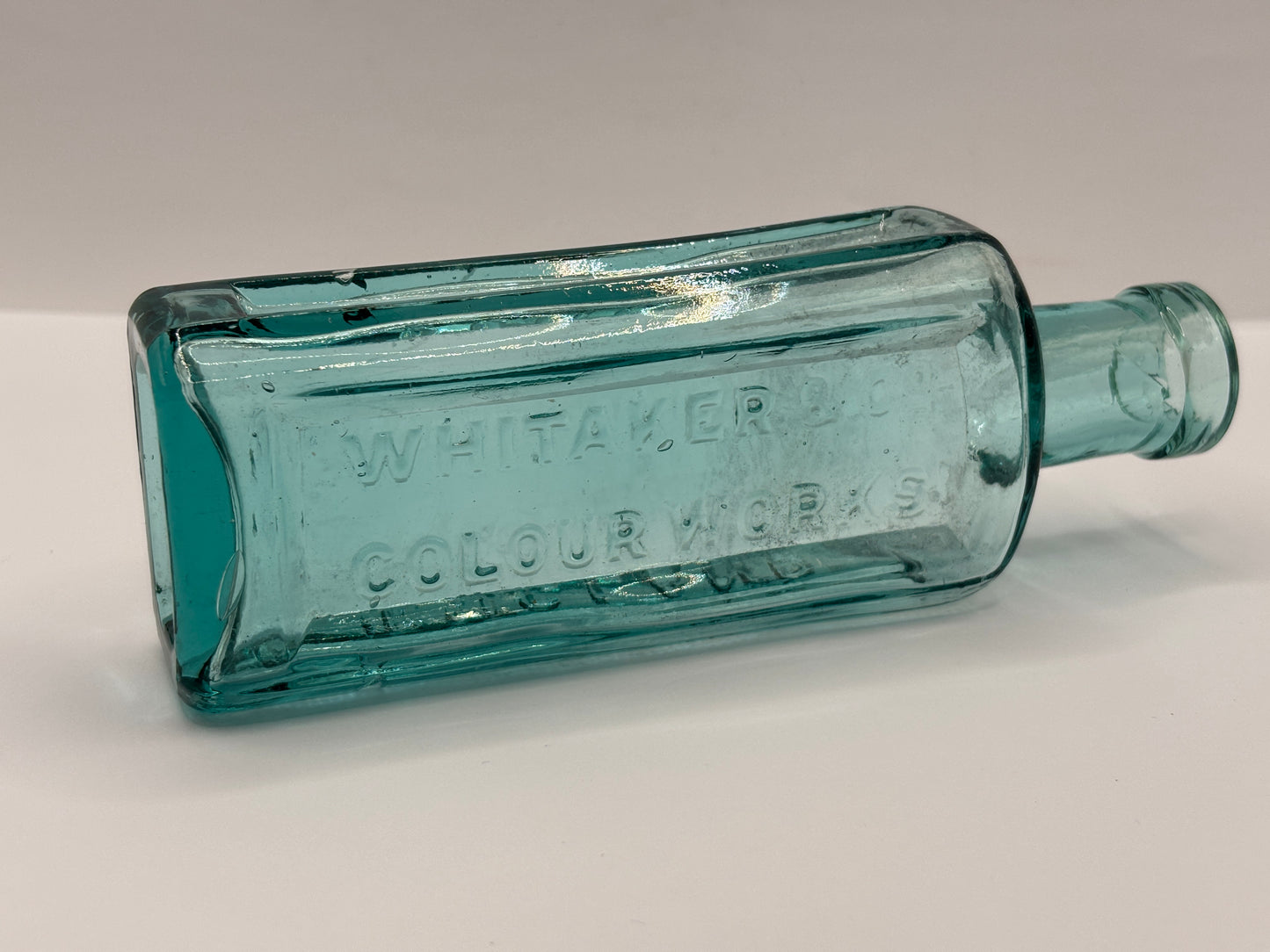 Old advertising aqua glass chemist bottle, Whittakers colour works