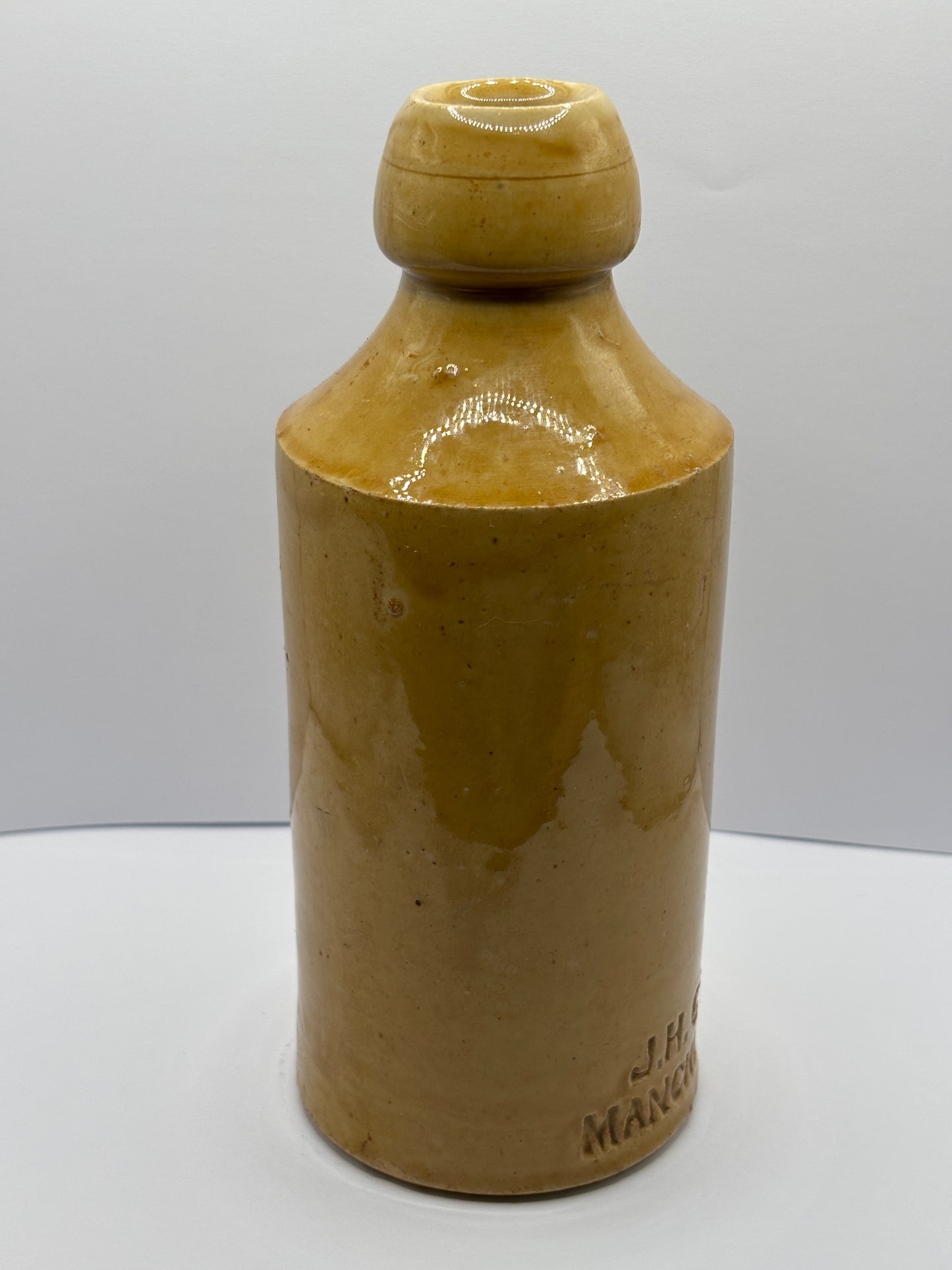 Old impressed stoneware ginger beer bottle, J.H Cuff Manchester