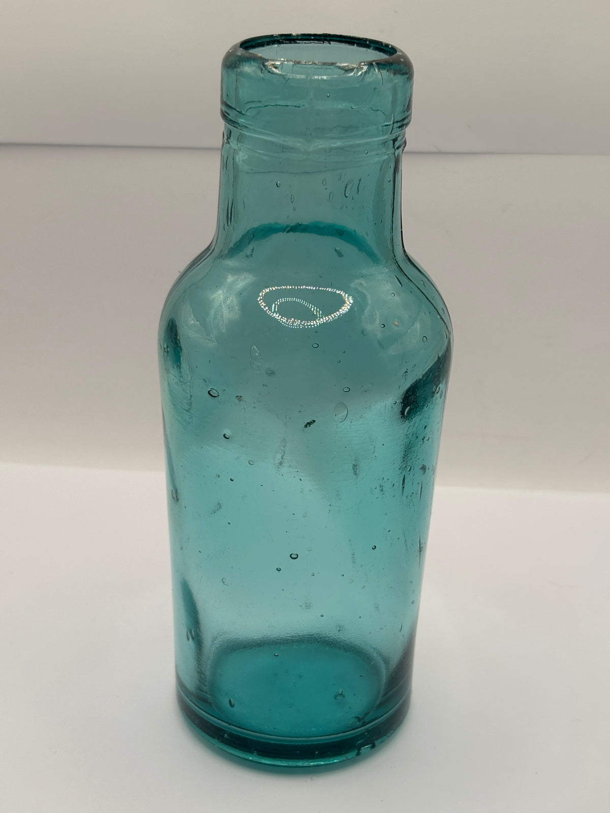 Old dark aqua glass jar