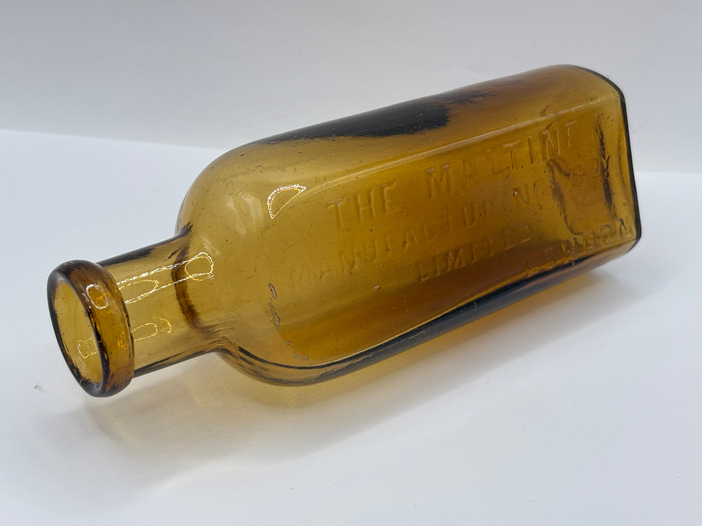 Old amber glass advertising chemist bottle, The Maltine manufacturing company